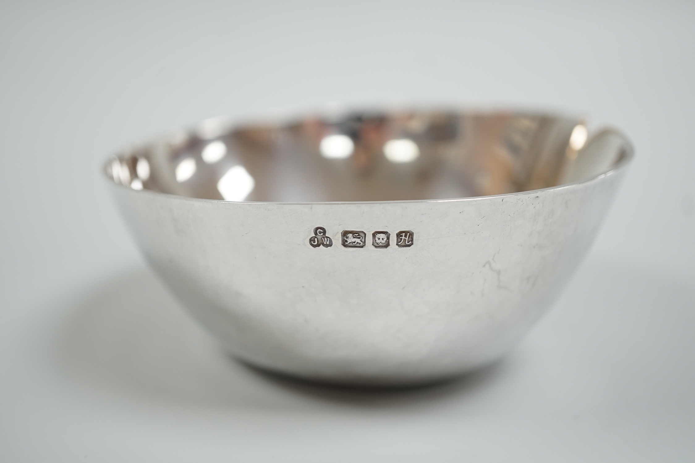 A modern silver dimpled bowl, maker CJW, London, 1982, width 10cm, 116 grams.